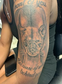 a woman with a tattoo of a lion on her arm