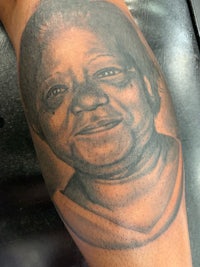 a black and white tattoo of an old woman