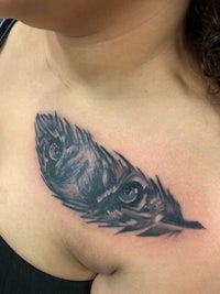 a woman with a feather tattoo on her chest