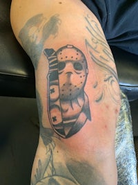 friday the 13th tattoo on a person's thigh