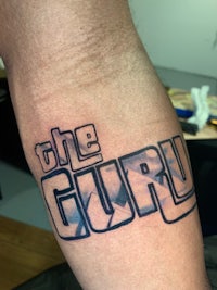 a tattoo with the word'the guru'on it