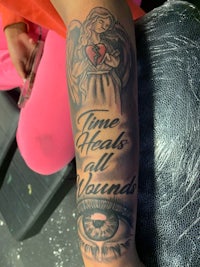 a woman's arm with a tattoo that says time heals all wounds