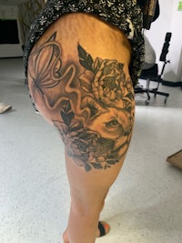 a woman with a tattoo on her thigh